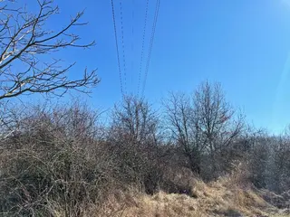 Id. spoluvlastnický podíl 1/18 na pozemcích v k.ú. Újezd nad Lesy o celkové výměře 5647 m2